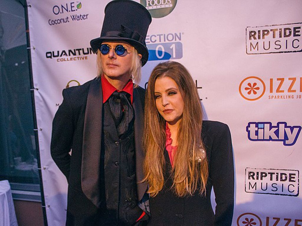 Lisa Marie Presley and her husband Michael Lockwood at a press event.