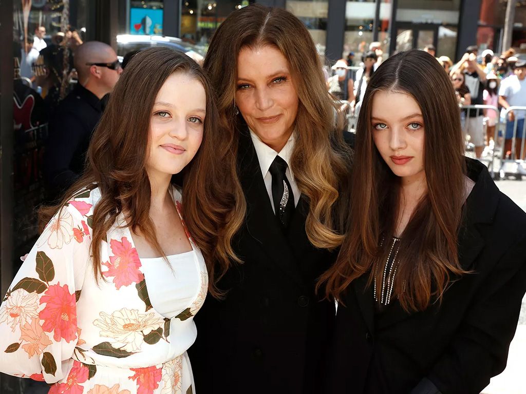 Lisa Marie Presley and her twin daughters Finley and Harper at a press event.
